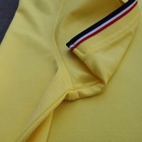 Chi tiết sản phẩm áo cổ trụ polo bo sọc cá sấu lạnh poly thấm hút màu vàng