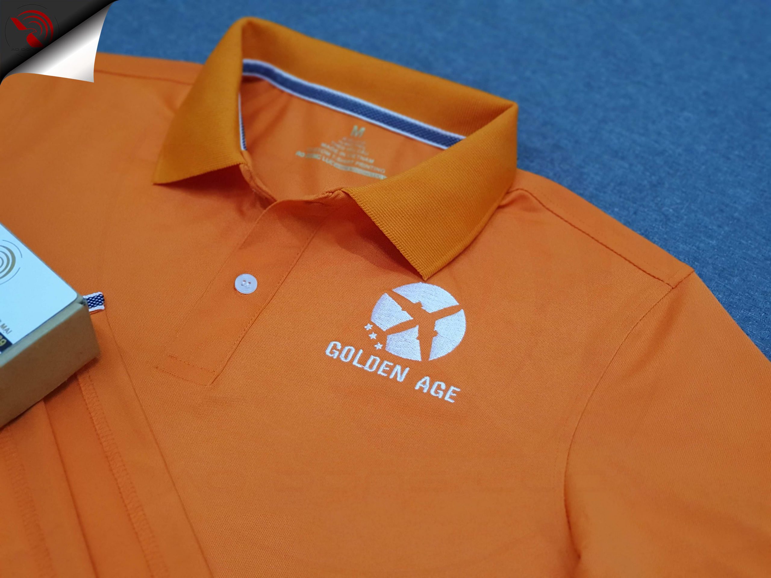 Đồng phục áo thun polo bo trơn màu cam thêu logo